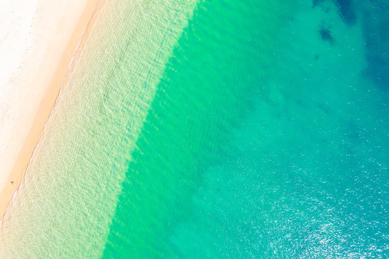Aerial top down view of pristine Emerald Coast beach with turquoise water